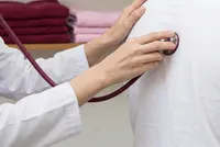 A stethoscope with burgundy tubing