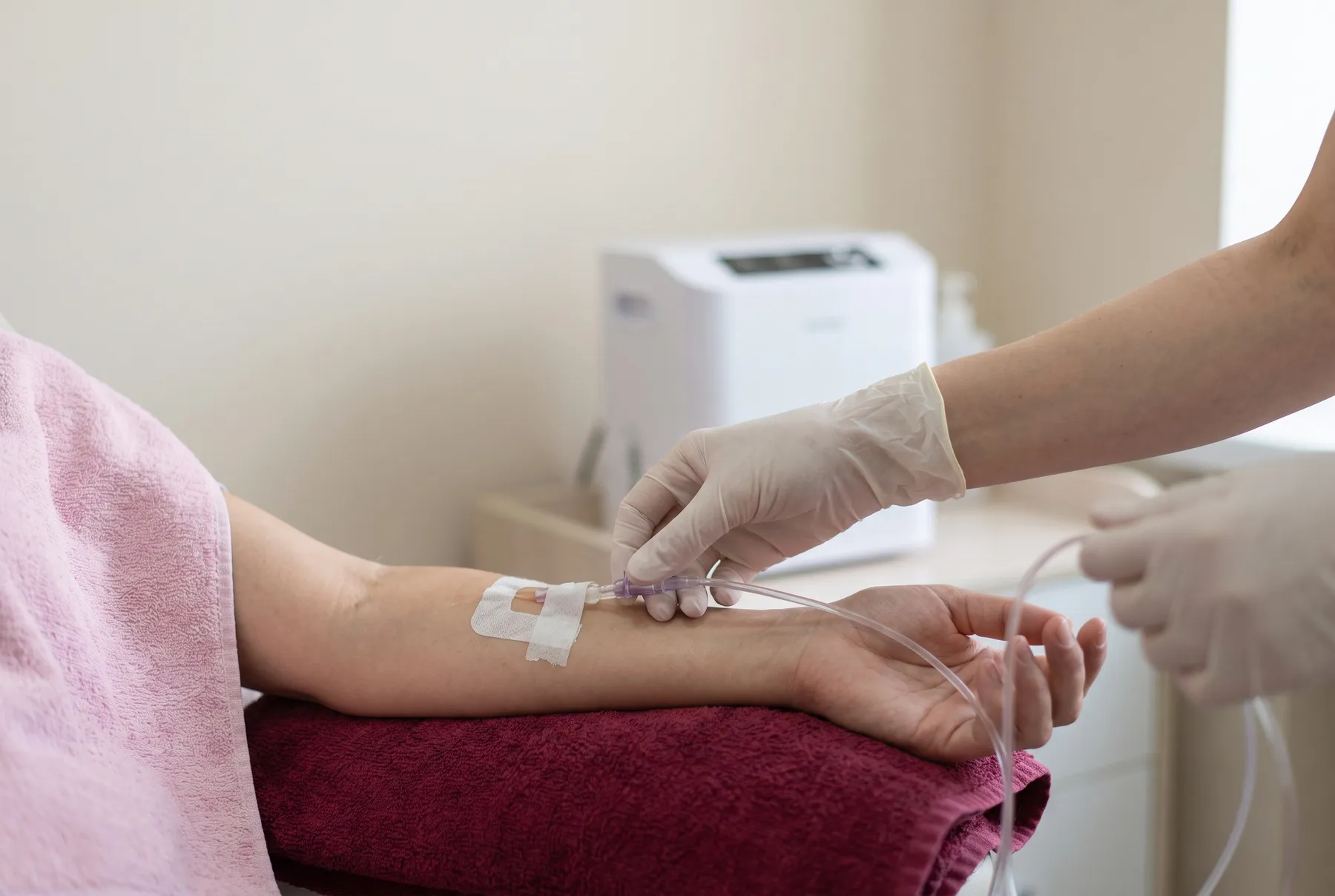 A drip line connected to a cannula in the arm, with an ozone device