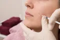 Four glass vials of graduated heights
